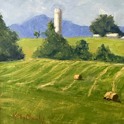 Detail of Landscape painting of a green field with haybales, a farm in the background and blue mountains in the distance against a blue sky by Kathy Chumley - Cottage Curator - Sperryville VA Art Gallery