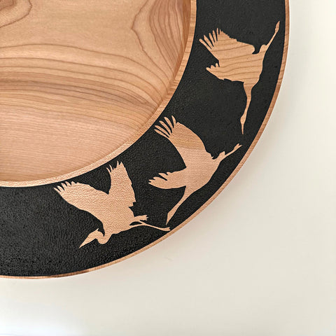 Detail of wood-turned plate with black rim and bird silhouette cutouts by Steve Schwartz at Nature's Studio Art Gallery - Front Royal VA