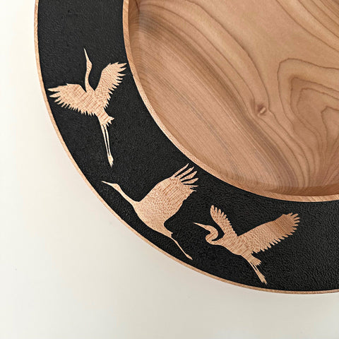 Detail of wood-turned plate with black rim and bird silhouette cutouts by Steve Schwartz at Nature's Studio Art Gallery - Front Royal VA