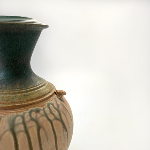 Detail of Symmetrical ceramic vessel with green upper and tan lower glazing and small handles by Richard Aerni at Cottage Curator - Sperryville VA Art Gallery