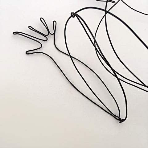 Detail of black wire sculpture of frog by Janet Brome