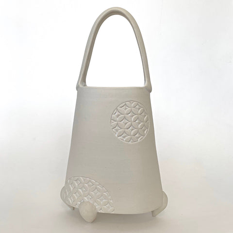 All white porcelain vessel with handle and circle with pattern on the side by Yoshi Fujii at Cottage Curator - Sperryville VA Art Gallery