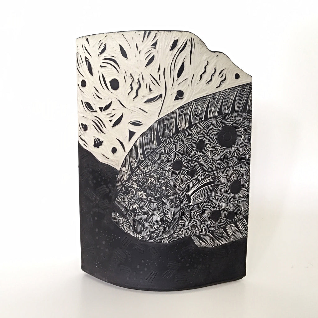 Vase with carving of flounder with head visible in black and white by Shirley Gromen