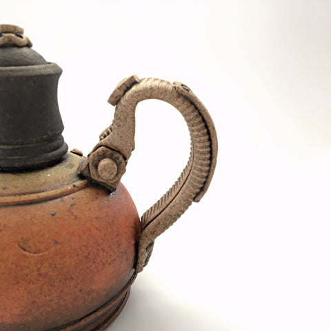 Detail view of industrial ceramic teapot with rivets by Steve Palmer