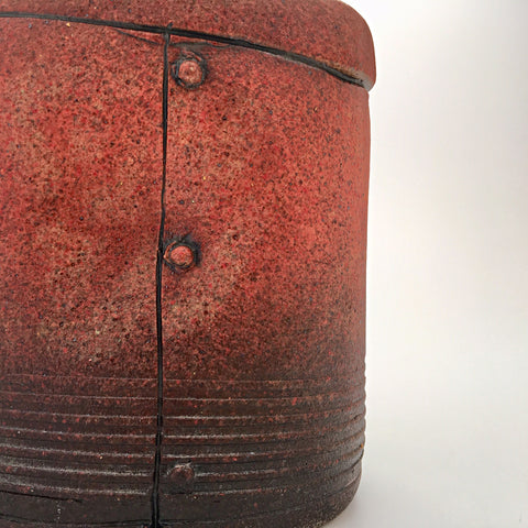 Detail of red ceramic industrial flask vessel with seams by artist Steve Palmer