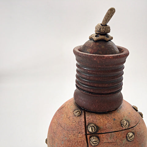 Detail view of industrial ceramic vessel with rivets by Steve Palmer